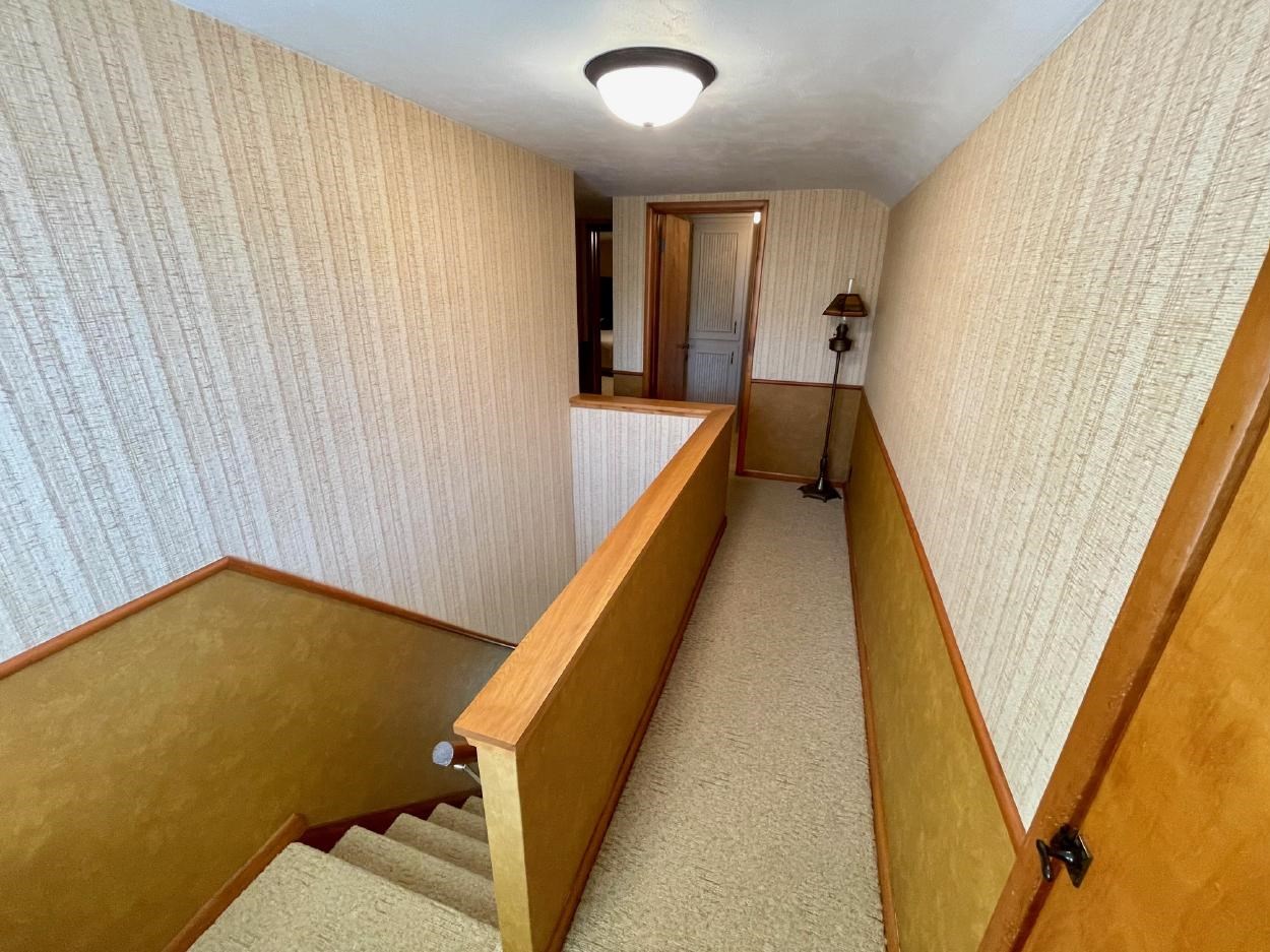 stairway and hallway to upper level...lots of storage