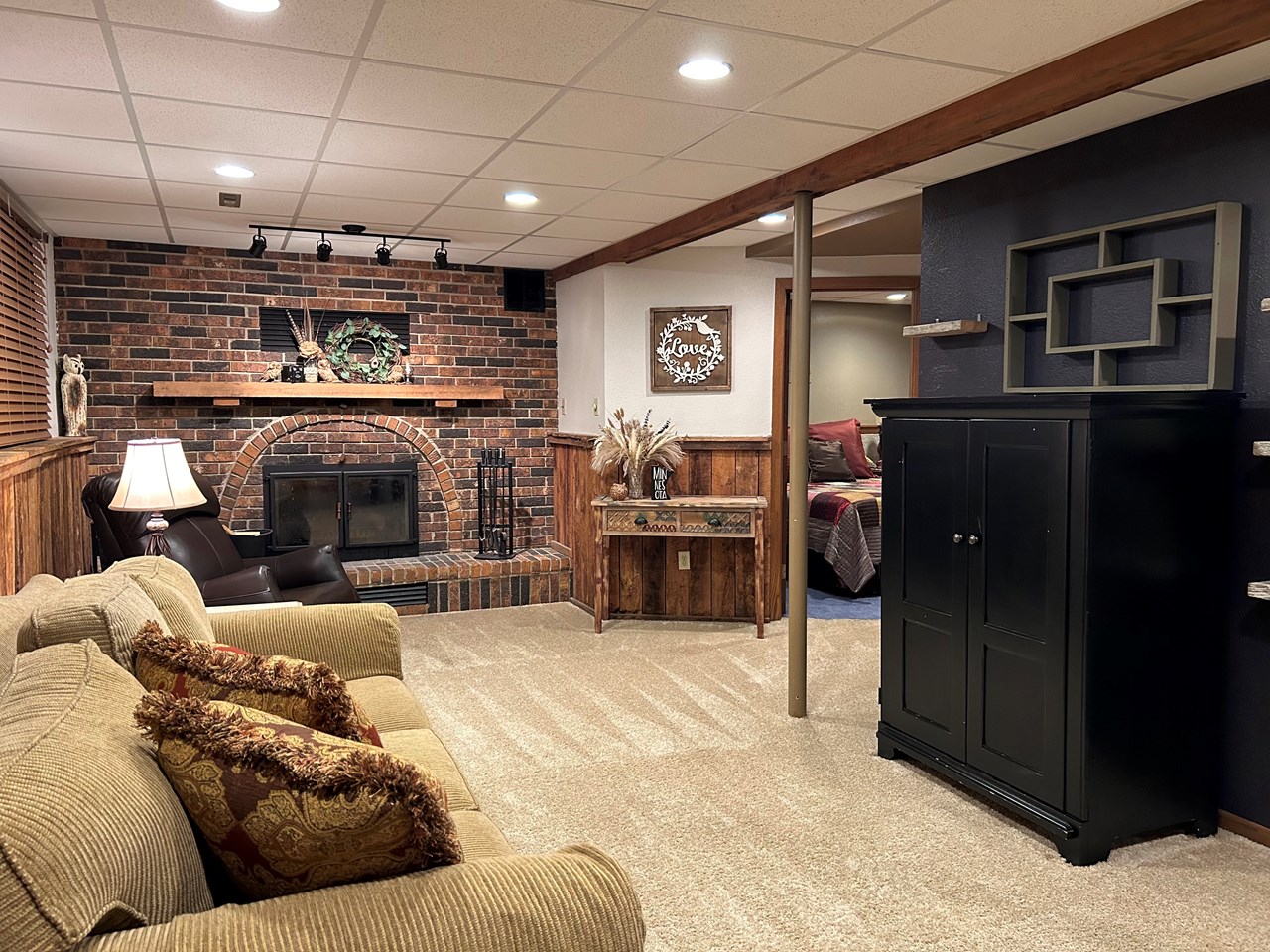lower level gathering room with wood burning fireplace