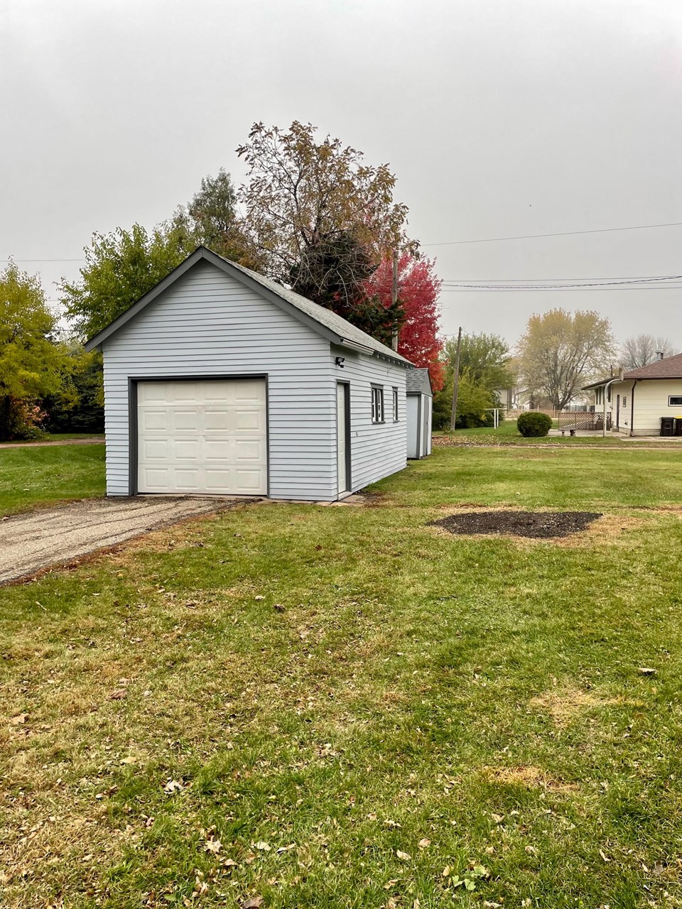 detached garage and shed behind