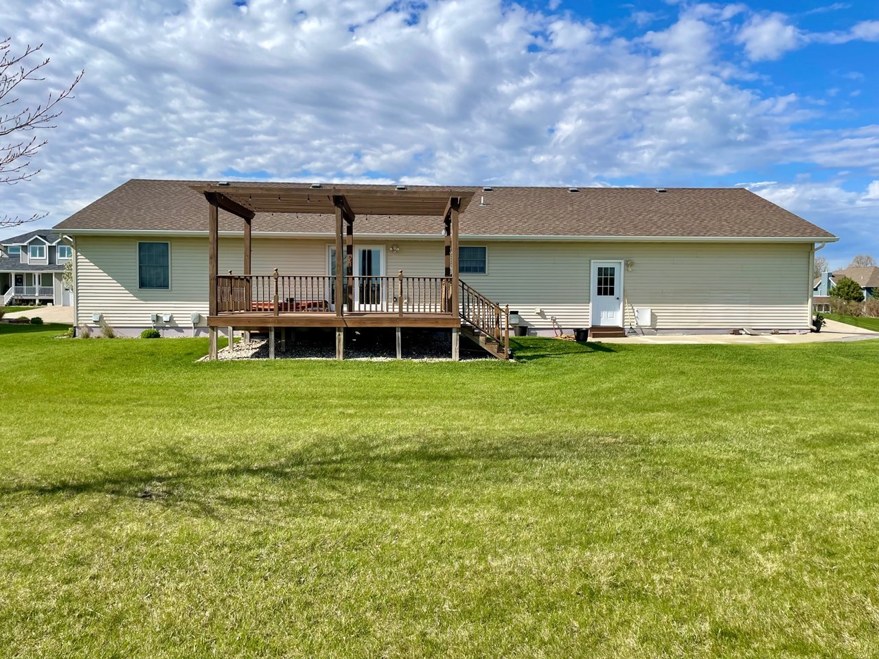 view of backside of home and deck and hot tub area