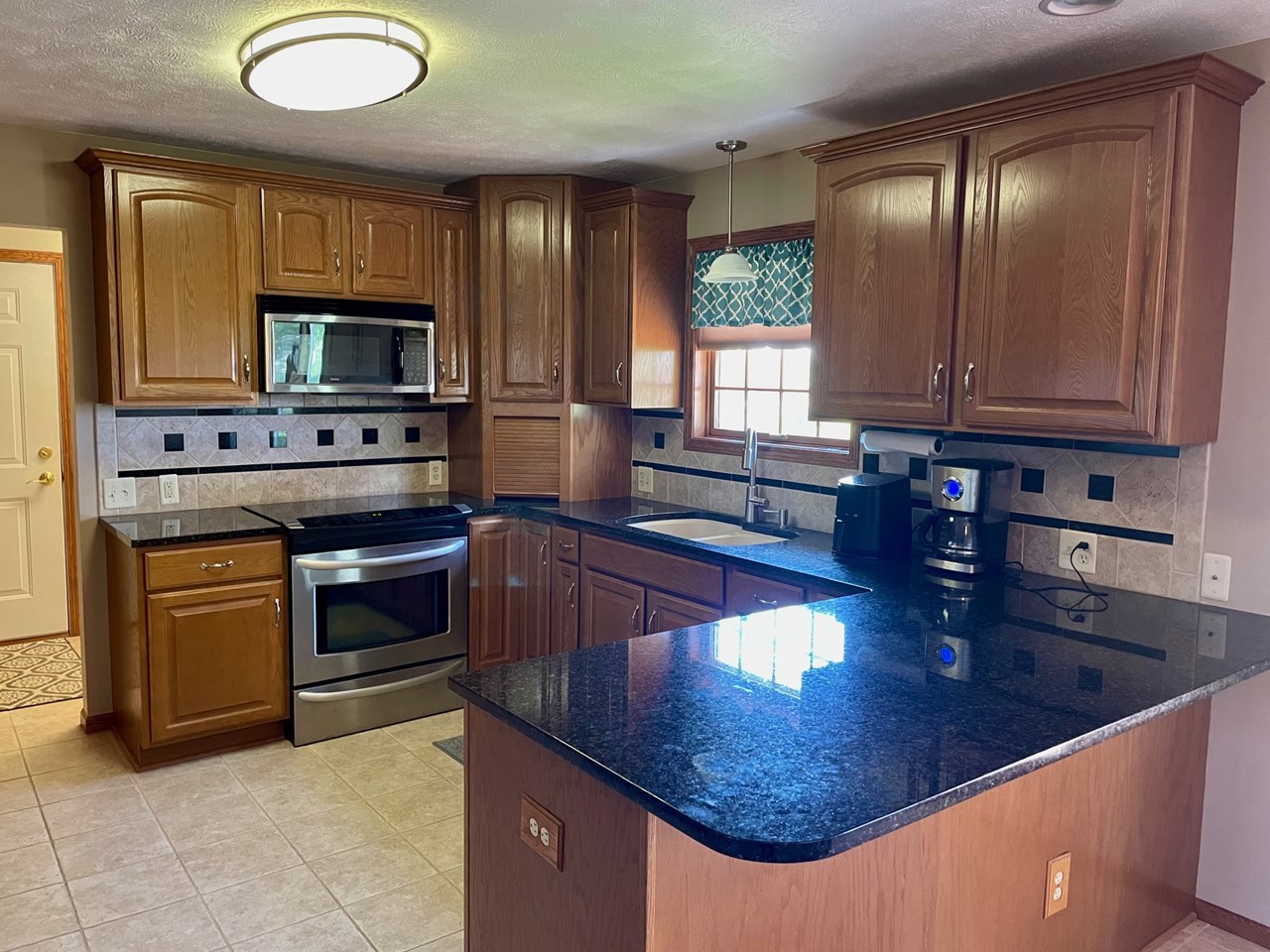 kitchen with granite countertop and open to dining area
