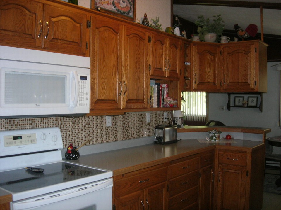 kitchen with custom built cabinets with newer backsplash