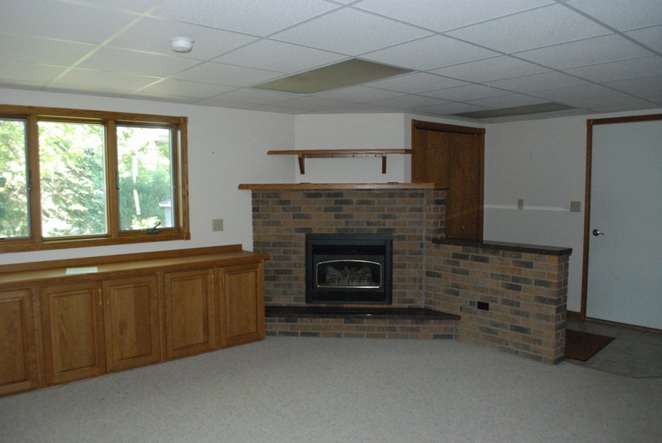 family room area in lower level w/ a kitchen area