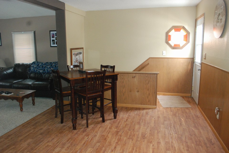 dining room area with door to deck and stairway to lower level
