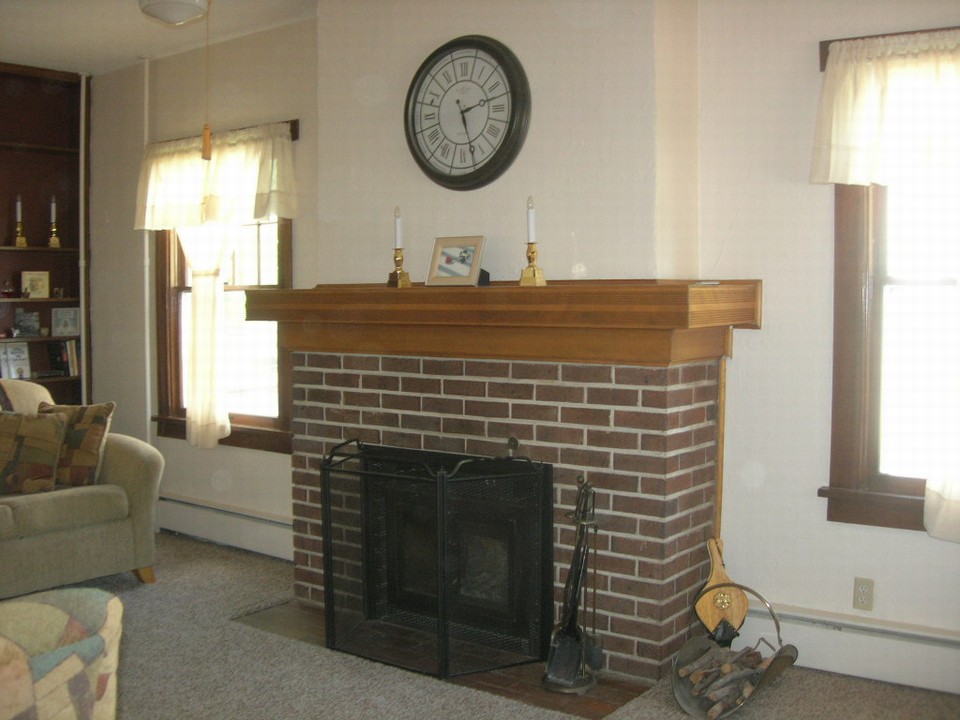 wood fireplace on main floor living room