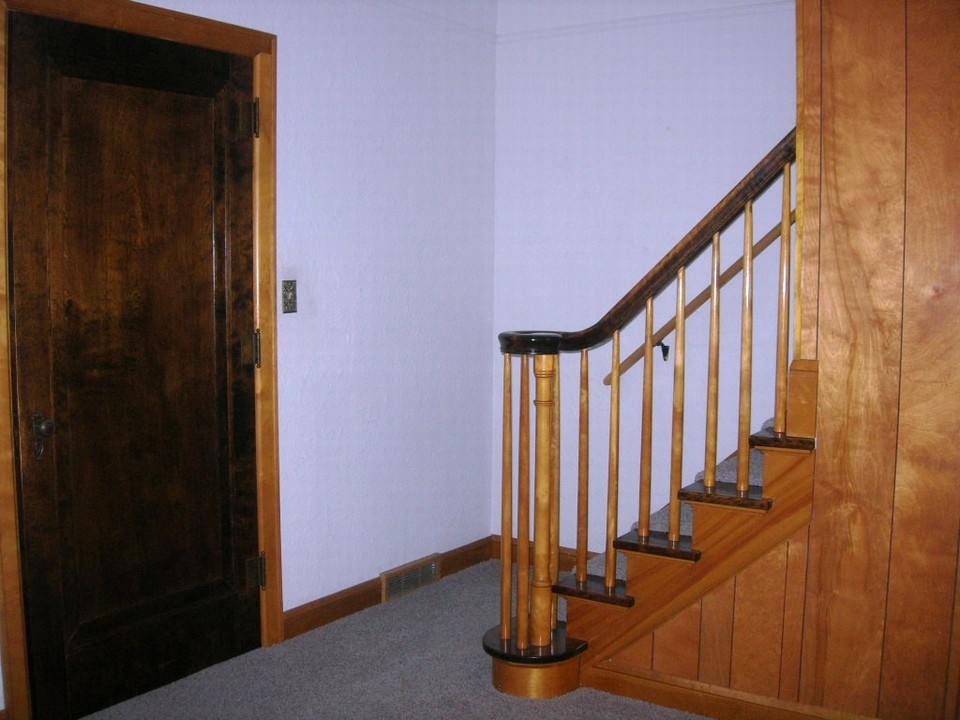 open stairs off the living room to upstairs and front entry