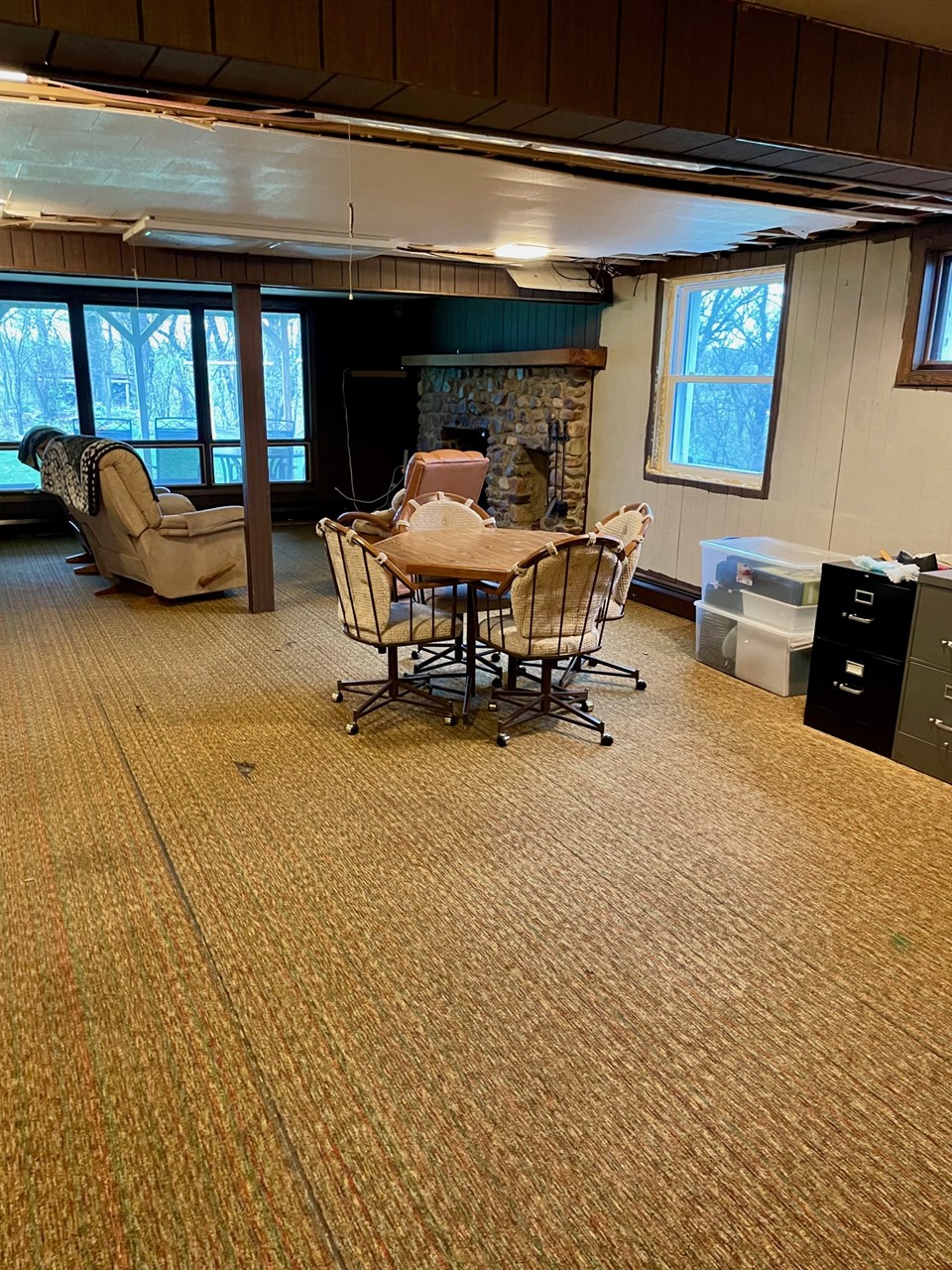 large family room in lower level with fireplace and walk-out to patio