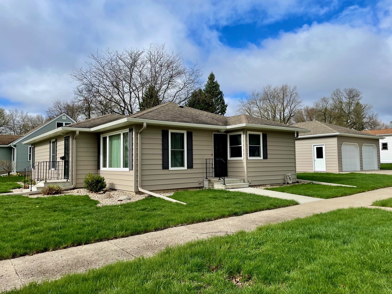 nice two bedroom home on a corner lot with a large detached garage with patio