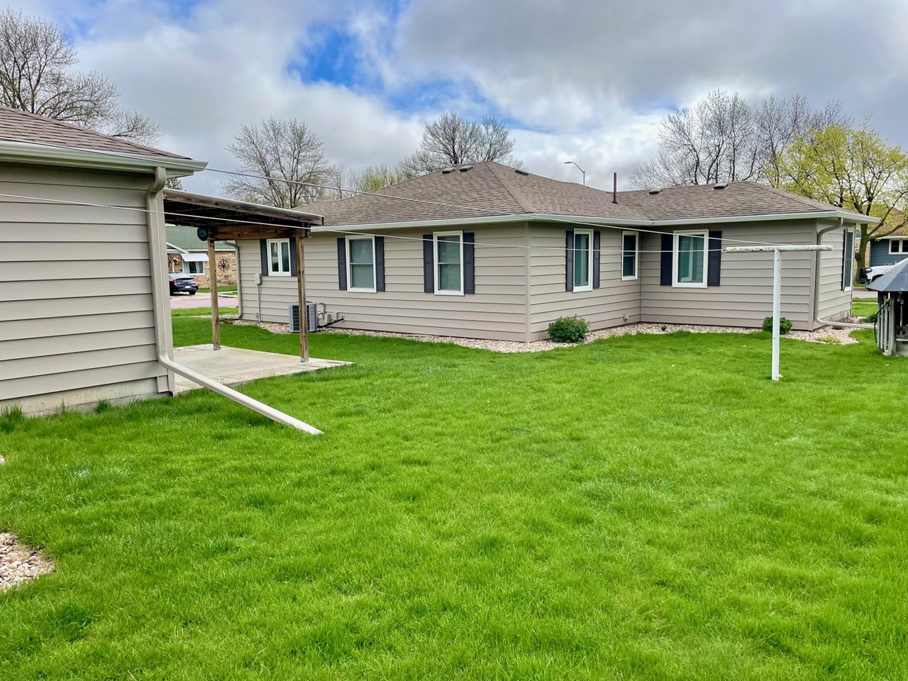 view of backside of home and patio area off garage