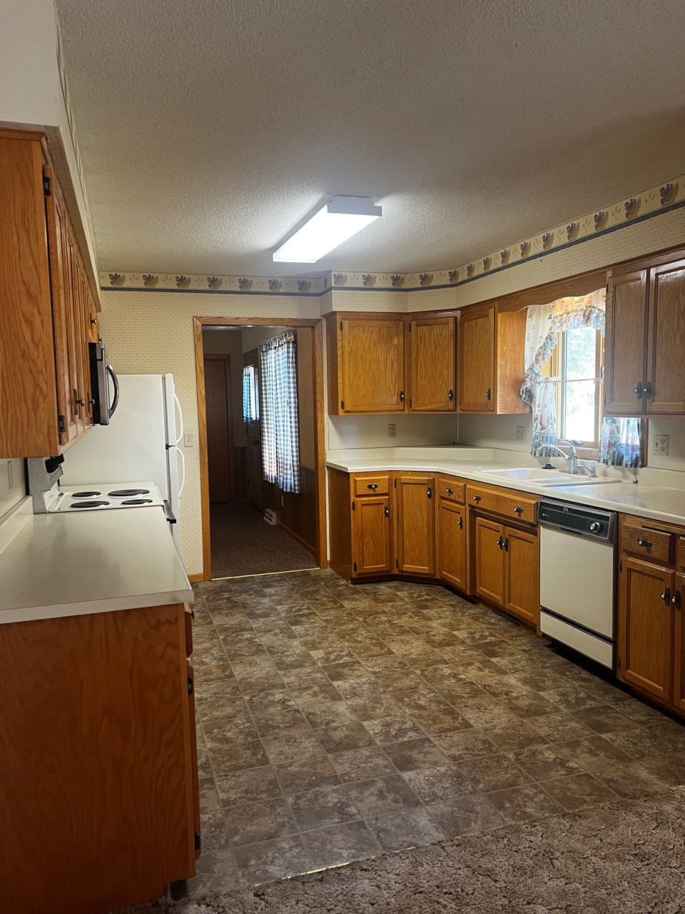 kitchen with custom built cupboards open to dining area