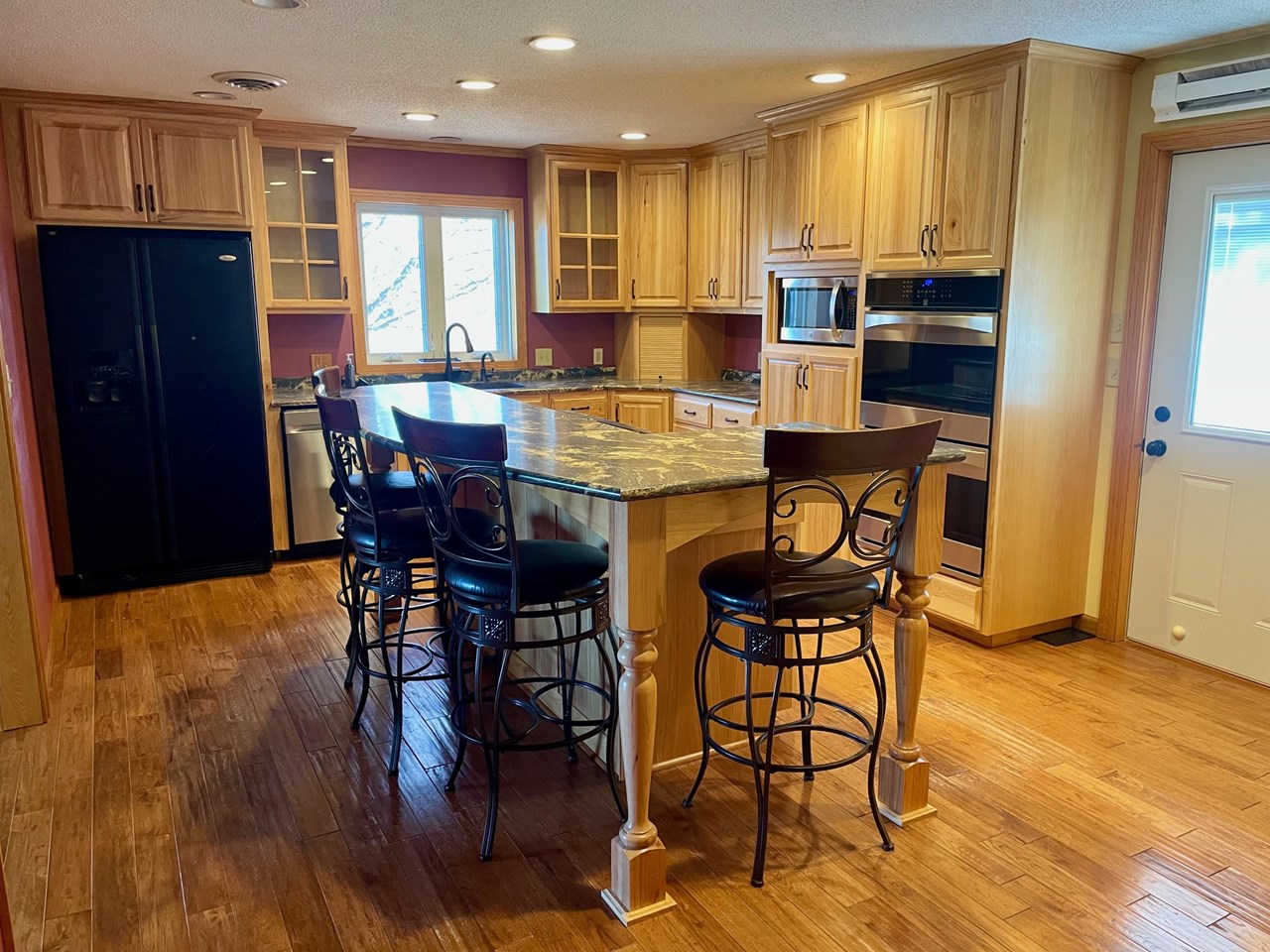 updated kitchen with a great island and stovetop w/ seating