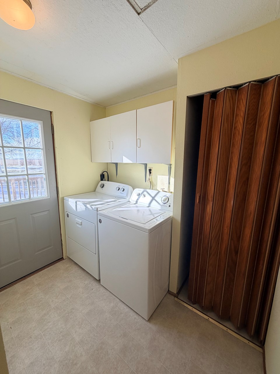 main floor laundry and storage with access to large deck