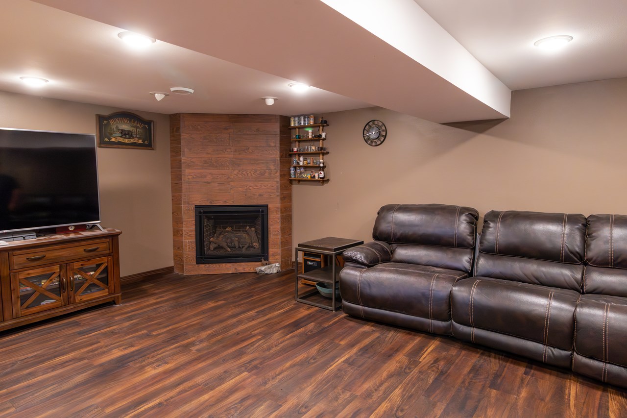 finished portion of basement with kozy heat fireplace